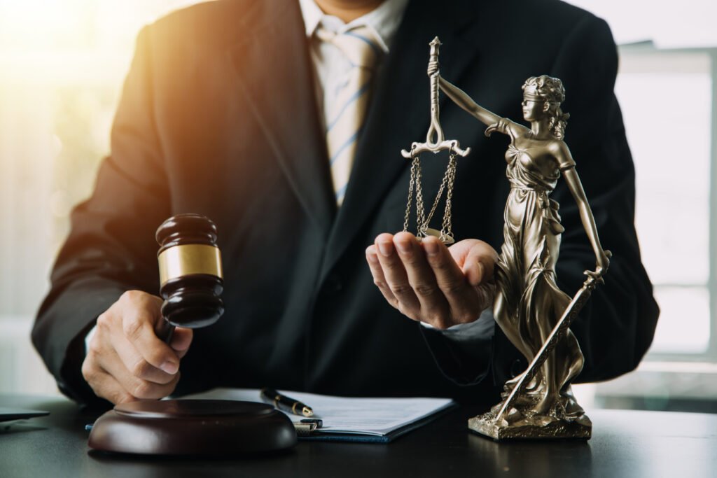 Business and lawyers discussing contract papers with brass scale